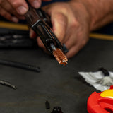 Product lifestyle image of Shooter's Choice .45cal Pistol Cleaning Kit bronze bore brush in use