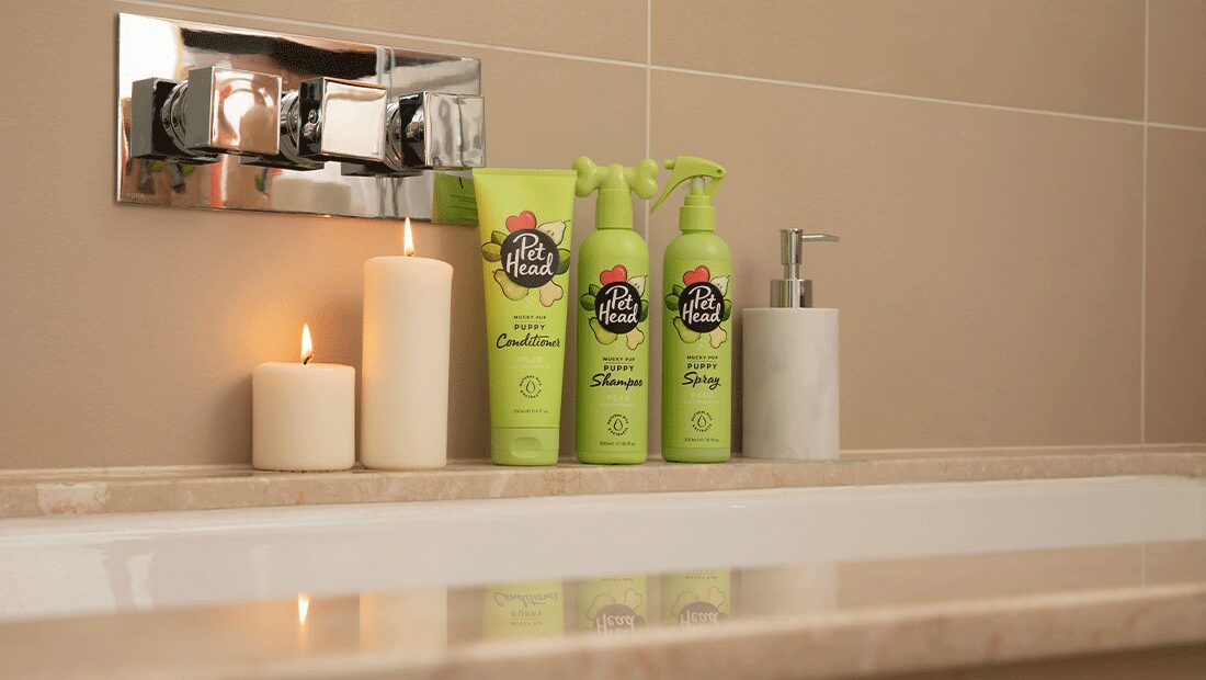 Mucky Pup collection in bathroom setting with candle