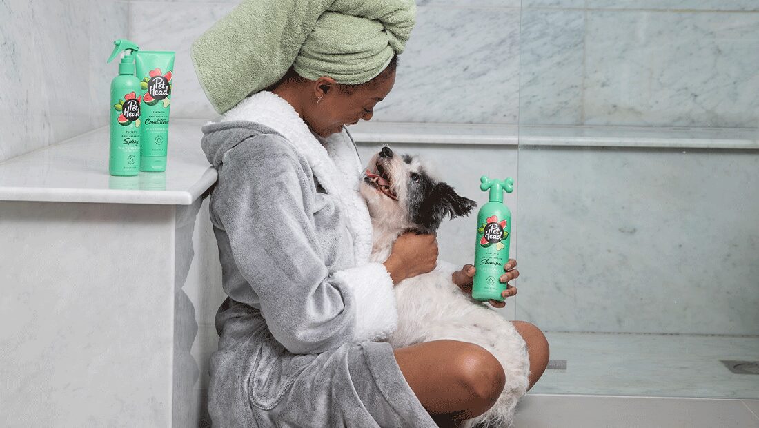 lady smiling at her Terrier after her shower