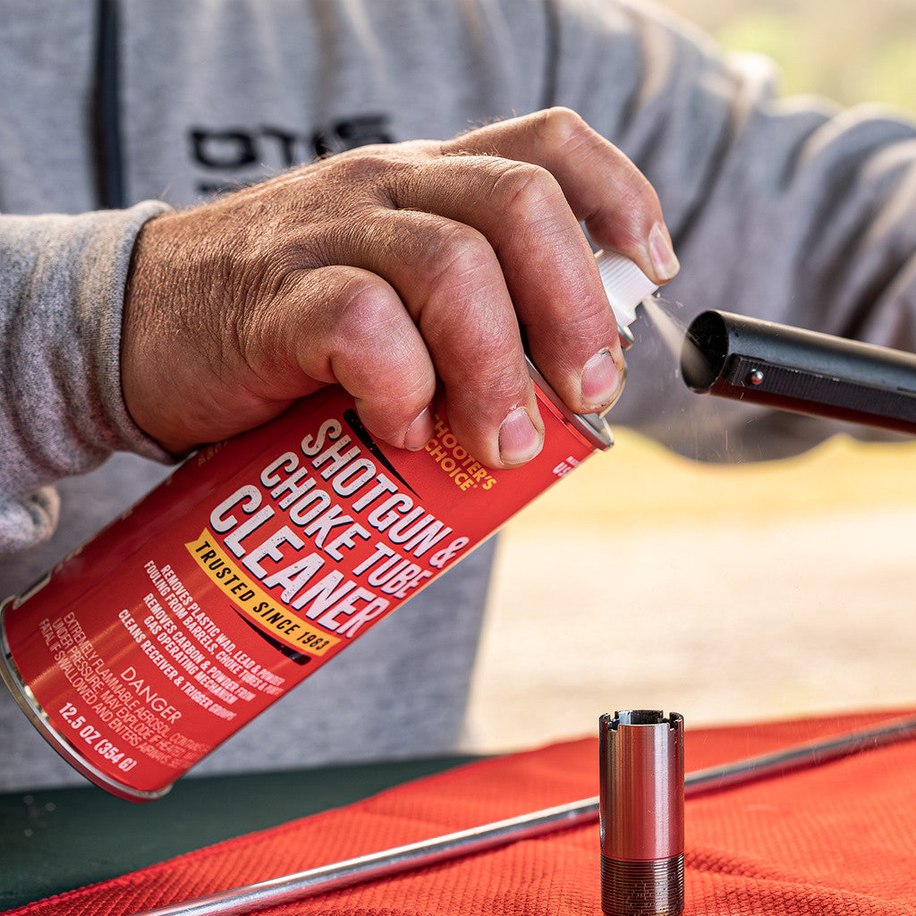 Product image of Shooter's Choice Shotgun and Choke Tube Cleaner  in use cleaning a shotgun choke tube