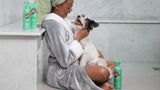 Happy owner laughing with her Terrier in bathroom after a shower